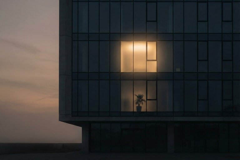 City building at dusk with one illuminated window representing the independent web